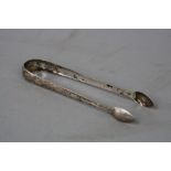 A PAIR OF GEORGE III IRISH PROVINCIAL BRIGHT CUT SUGAR TONGS, circa 1790, stamped Sterling and