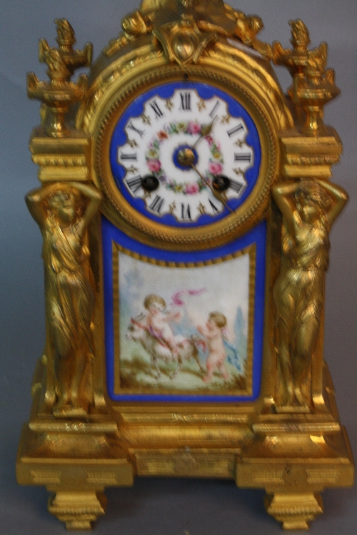 A MID 19TH CENTURY STYLE GILT METAL MANTEL CLOCK, putti surmounting an arched top with circular - Image 2 of 2