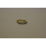 A MODERN YELLOW GOLD DIAMOND HALF HOOP RING, carved scroll design sides and shoulders, five modern