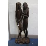 TRIBAL INTEREST, a carved hardwood figure group of an African male and female, height