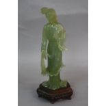 A LATE 19TH CENTURY CHINESE GREEN JADE FIGURE, of a lady wearing flowering robes (s.d.), together