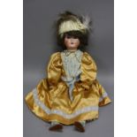 A SCHOENAU & HOFFMEISTER BISQUE HEAD DOLL, nape of neck marked with the star logo and '1909 5 1/2