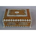 A LATE 19TH CENTURY INDIAN SANDALWOOD SARCOPHAGUS SHAPED WORK BOX, with ivory strap work and