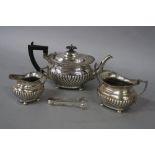 AN EDWARDIAN SILVER THREE PIECE BACHELORS TEA SERVICE, gadrooned rims, half gadrooned decoration