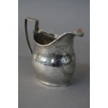 A GEORGE III SILVER HELMET SHAPED CREAM JUG, strap work handle (solder to join with jug), bright cut