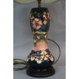 A MOORCROFT POTTERY OBERON PATTERN TABLE LAMP, mounted on a wooden plinth base, together with a pale