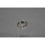 A MODERN EMERALD AND DIAMOND DRESS RING, one marquise cut emerald measuring approximately 5.5mm x