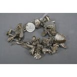 A SILVER CHARM BRACELET, approximate weight 88.5 grams