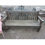 A HEAVY HARDWOOD SLATTED GARDEN BENCH, approximate length 167cm