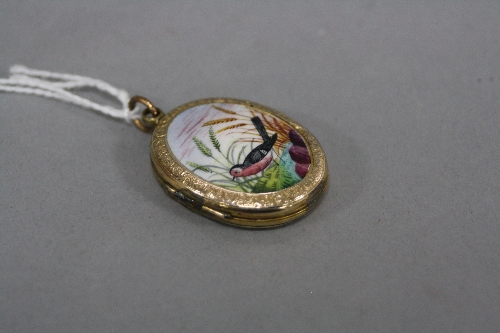 A 9CT ENAMELLED LOCKET (damage to back of locket)