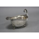 A MAPPIN & WEBB GEORGE V SILVER SAUCE BOAT, beaded rim 'S' scroll handle, on three cabriole legs