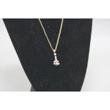 A MODERN 9CT GOLD RUBY AND DIAMOND PENDANT, one pear shape ruby measuring approximately 6.88mm x