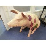 A LIFESIZE RESIN MODEL OF A SEATED PIG, florally decorated and marked 'Piggy in Pink' Lorna Faith