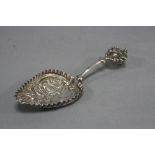 A 19TH CENTURY CONTINENTAL SILVER SPOON, the bowl embossed with cow in a landscape, fruit and