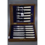 A LATE VICTORIAN OAK CASED SET OF SIX SILVER FRUIT KNIVES AND FORKS, engraved decoration, ivory