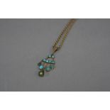 AN EARLY 20TH CENTURY TURQUOISE FRINGE DROP PENDANT, together with a trace link chain, fitted to a
