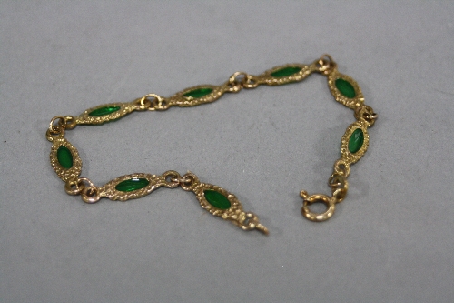 A 9CT BRACELET, set with eight green stones, approximate length 17cm