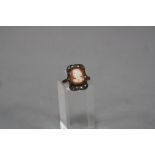A MID- 20TH CENTURY SHELL CAMEO AND MARCASITE DRESS RING, ring size K, stamped '9ct and Sil',