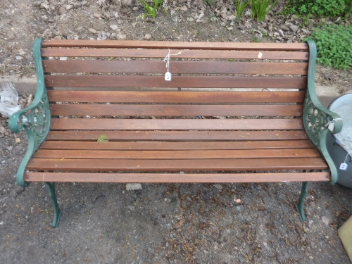 A HARDWOOD SLATTED GARDEN BENCH, with painted cast iron ends, approximate length 126cm