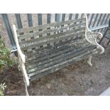 A SLATTED GARDEN BENCH, with painted cast iron ends, approximate length 125cm (sd)