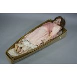 A BISQUE HEAD DOLL, makers name to nape of neck obscured by wig, possibly Thuringia, sleeping
