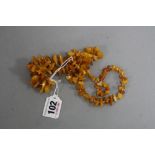 A STRING OF IRREGULAR AMBER BEADS