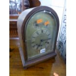 AN OAK CASED DOME TOP MANTLE CLOCK, dial marked 'Arnold & Lewis Manchester' (key and pendulum) (sd)