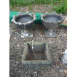 A PAIR OF PRE-CAST GARDEN URNS, on seperate bases, square garden urn, metal three branch stand and a