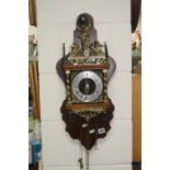 A REPLICA WALL CLOCK (brass weights on table)