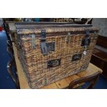 A LARGE 20TH CENTURY WICKER BASKET, with metal bounding including handles (sd)