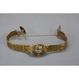 A 9CT TIARA LADIES WATCH, on a 9ct bracelet, approximate weight 23.5 grams