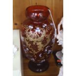 A CRANBERRY GLASS FOOTED VASE, with painted flowers and gilt details, height approximately 28cm (