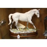 A ROYAL DOULTON LIMITED EDITION HORSE, 'Desert Orchid' DA134, 536/7500 on wooden plinth, with