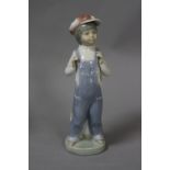 A LLADRO FIGURE, boy in dungarees with accordion, height approximately 22cm