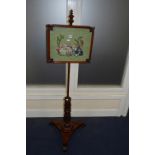 A VICTORIAN MAHOGANY POLE SCREEN, square screen inset with needlework tapestry, on concave triform