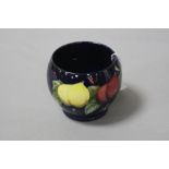 A MOORCROFT POTTERY SUGAR BOWL, 'Wisteria' pattern on blue ground, impressed and painted marks to