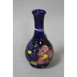 A MOORCROFT POTTERY BUD VASE, 'Clematis' pattern, impressed marks to base, height approximately