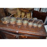 A SET OF SEVEN GRADUATING COPPER PANS