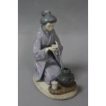 A LLADRO FIGURE, kneeling oriental lady with tea bowl, height approximately 22cm