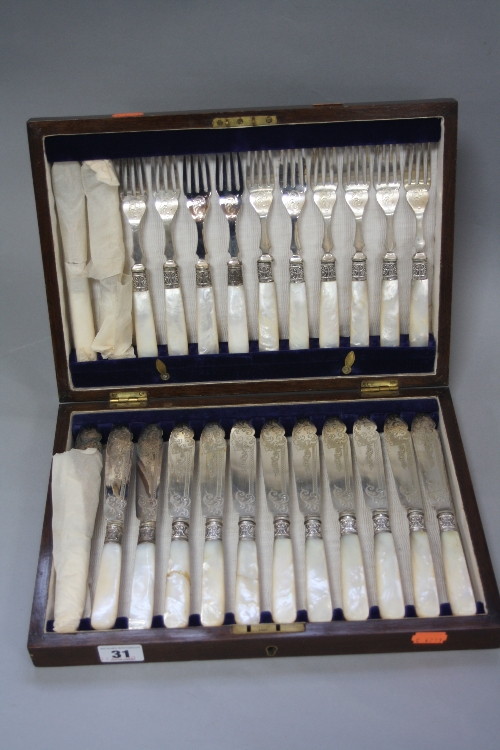 A CASED SET OF TWELVE EDWARDIAN FISH EATERS, mother of pearl handles, two a.f., EPNS fittings and