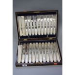 A CASED SET OF TWELVE EDWARDIAN FISH EATERS, mother of pearl handles, two a.f., EPNS fittings and