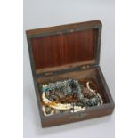 A WOODEN BOX OF MIXED ETHNIC JEWELLERY