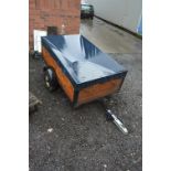 A SMALL SINGLE AXIS WOODEN TRAILER, with cover and spare wheel, approximate size length 154cm x