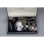 A MIXED LOT OF VARIOUS SILVER ITEMS, including charms, locket, T bar chain, bangle, cufflinks and