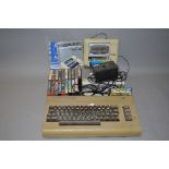 A COMMODORE 64 VINTAGE GAMING CONSOLE, with it's original power supply and manual, a 1530 Datassette