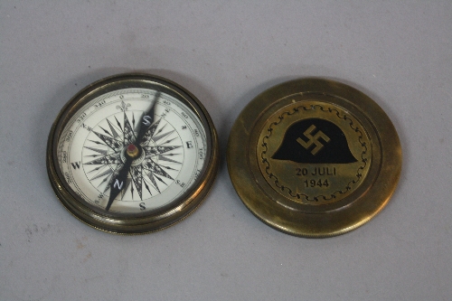 A BRASS ROUND WWII ERA GERMAN COMPASS, with screw top lid, bearing a scrolled circular design, a