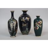 THREE JAPANESE CLOISONNE BALUSTER VASES, one decorated with six cranes flying over water and plants,