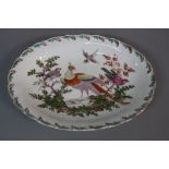 A CHELSEA PORCELAIN RED ANCHOR PERIOD OVAL DISH, feather moulded border in green and brown, the