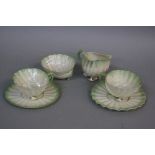 A BELLEEK SHELL SHAPED SIX PIECE TEASET, green titled highlights, comprising two cups, two