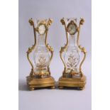 A PAIR OF MID 19TH CENTURY FRENCH ORMOLU AND ROCK CRYSTAL VASES, the vases of square baluster